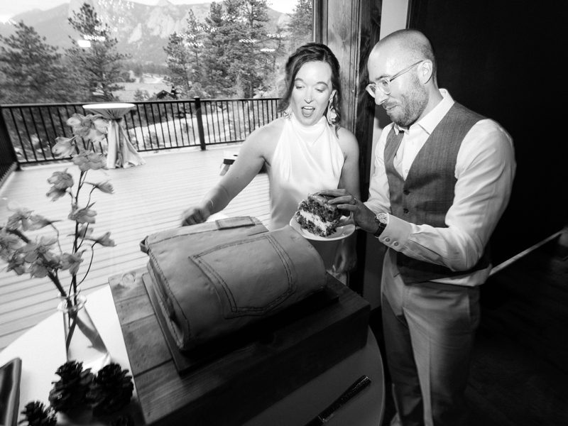 Black-and-white photo of a couple cutting the folded-jeans cake
